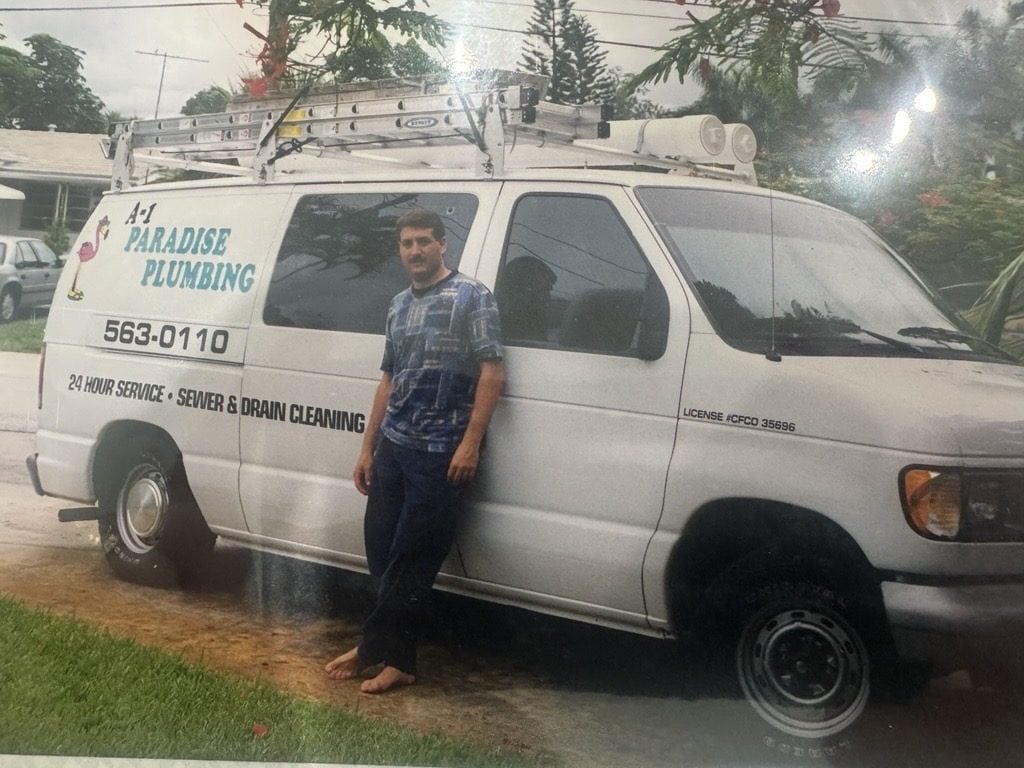 Matt Rich standing beside an early A-1 Paradise Plumbing van